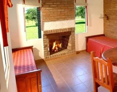 a living room with a fireplace in a house at El Portillo in Villa General Belgrano
