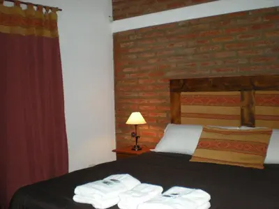 a hotel room with a bed with towels on it at El Portillo in Villa General Belgrano
