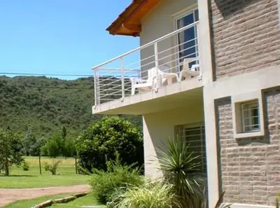 two dogs sitting on a balcony of a house at El Portillo in Villa General Belgrano
