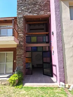 a building with a door with colorful stained glass at COSTA COM Departamentos de Montaña in Merlo