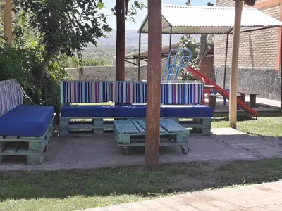 a playground with a blue bench and a slide at Hosteria Santa Francisca in Villa Cura Brochero