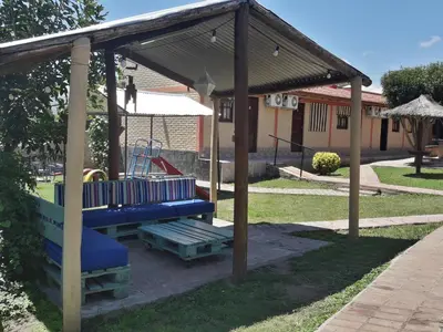 a playground with a blue bench and a swing at Hosteria Santa Francisca in Villa Cura Brochero