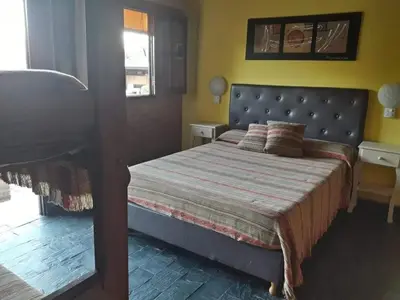 a bedroom with a bed and a window and a bed sidx sidx sidx at Hosteria Santa Francisca in Villa Cura Brochero
