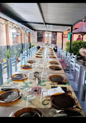 a long table with chairs and plates on it at Hosteria Santa Francisca in Villa Cura Brochero