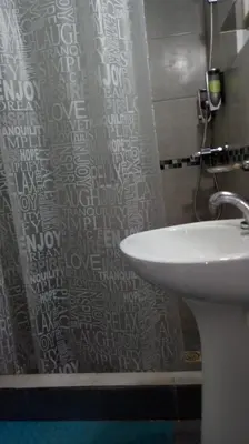 a bathroom with a sink and a shower curtain at Departamento MT 2 Barrio Jardín in Cordoba