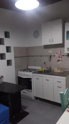 a kitchen with a stove and a sink in it at Departamento MT 2 Barrio Jardín in Cordoba