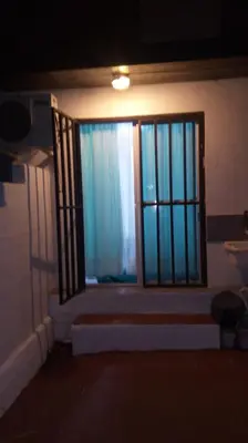 a room with a large window with blue curtains at Departamento MT 2 Barrio Jardín in Cordoba
