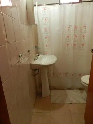 a bathroom with a sink and a toilet at Hostel Ctalamochita in Embalse