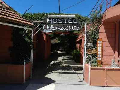 a sign for a hostel called colombian cuisine on a street at Hostel Ctalamochita in Embalse