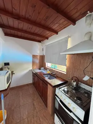 a kitchen with a stove and a sink at CASA PARA 6 PERSONAS MERLO SAN LUIS in Merlo