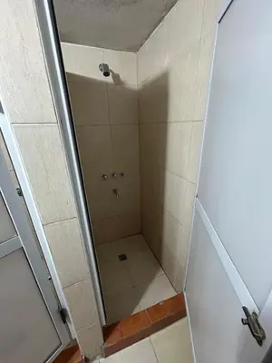 a shower with a glass door in a bathroom at Central Paz Hostel in Villa Carlos Paz