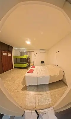 a bedroom with a large bed in an attic at Central Paz Hostel in Villa Carlos Paz