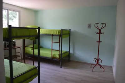 a room with two bunk beds in a room at Central Paz Hostel in Villa Carlos Paz
