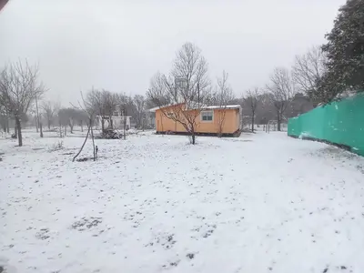 a snow covered field with a building in the background at Finca La Virreinita in Panaholma
