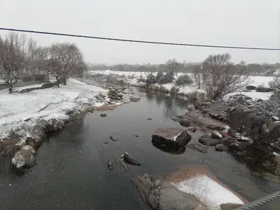 a river with rocks and snow on the ground at Finca La Virreinita in Panaholma