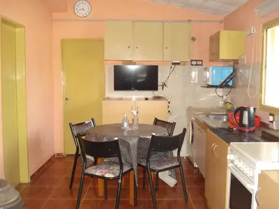 a kitchen with a table and chairs in a kitchen at Finca La Virreinita in Panaholma