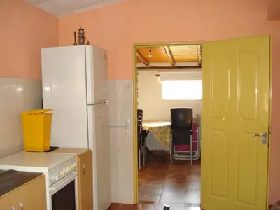 a kitchen with a white refrigerator and a green door at Finca La Virreinita in Panaholma