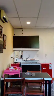a kitchen with a table and chairs and a counter at Apartamento Emir in Mina Clavero