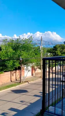 a view of a street with a gate and trees at Apartamento Emir in Mina Clavero