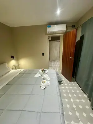 a hotel room with a bed with towels on it at Apart Las Palmeras Corcovado in Villa Rumipal