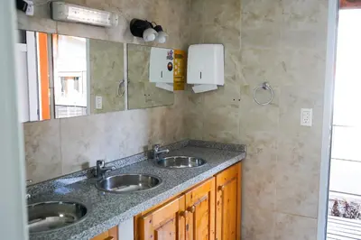 a bathroom with two sinks and a mirror at Eirú Hostel in Santa Rosa de Calamuchita