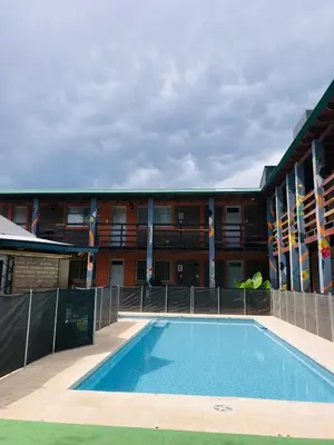 a swimming pool in front of a building at Eirú Hostel in Santa Rosa de Calamuchita