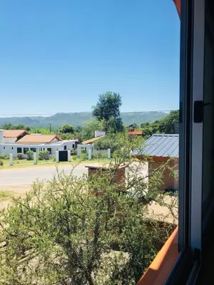 a view of a town from a window at Eirú Hostel in Santa Rosa de Calamuchita