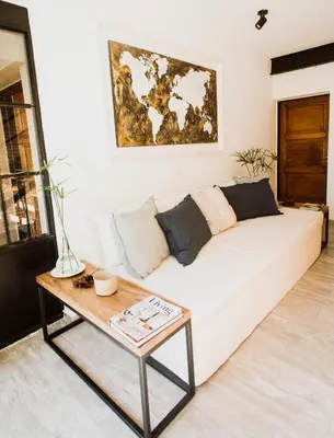 a living room with a white couch and a table at Casa Nuestra in Cordoba