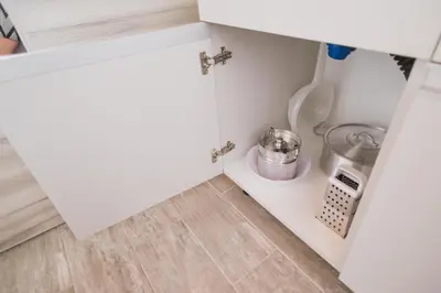 a small kitchen with a white cupboard with a sink at Casa Nuestra in Cordoba