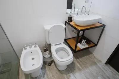 a bathroom with a toilet and a sink at Casa Nuestra in Cordoba