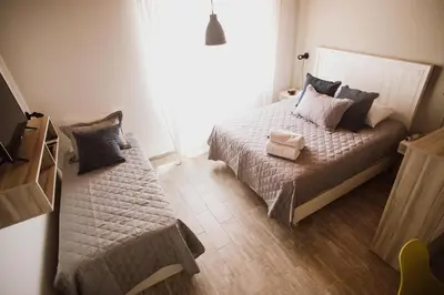 a small bedroom with a bed and a couch at Casa Nuestra in Cordoba