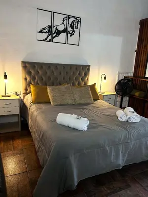 a bedroom with a large bed with towels on it at Tacuifi I - Apartamentos in Los Reartes