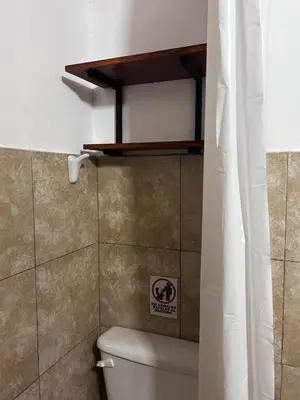 a bathroom with a toilet with a no smoking sign on the wall at Tacuifi I - Apartamentos in Los Reartes