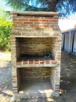 an outdoor brick oven sitting in a yard at Tacuifi I - Apartamentos in Los Reartes