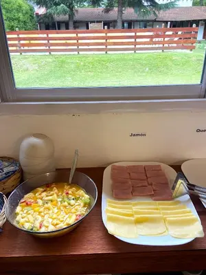 a table with a plate of food and a plate of cheese at Tacuifi I - Apartamentos in Los Reartes