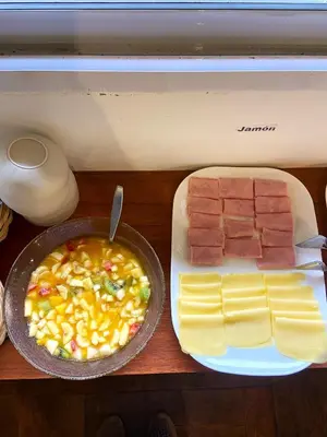 a table with a plate of food with meat and cheese at Tacuifi I - Apartamentos in Los Reartes