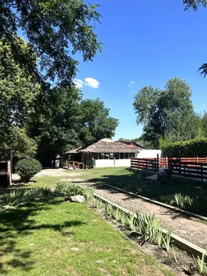 a building with a fence and a grass field at Tacuifi I - Apartamentos in Los Reartes