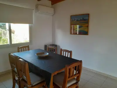 a dining room with a black table and chairs at La Allandesa in Cavalango