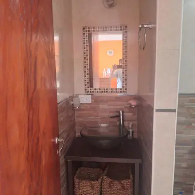 a bathroom with a sink and a mirror at La Allandesa in Cavalango