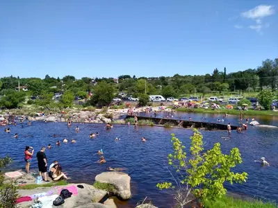 a group of people swimming in a lake at La Allandesa in Cavalango