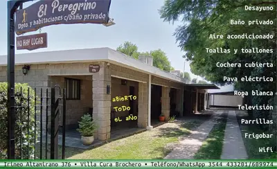 a building with a street sign in front of it at Hostería El Peregrino in Villa Cura Brochero