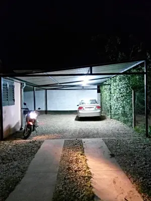 a car garage with a car parked in it at Hostería El Peregrino in Villa Cura Brochero
