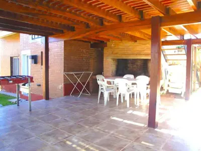 a large patio with a table and chairs on it at Chalets Los Abedules in Villa General Belgrano