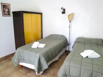 a bedroom with two beds with towels on them at Chalets Los Abedules in Villa General Belgrano