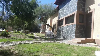 a house with a window on the side of it at Cabañas Corazon de Maria in Merlo