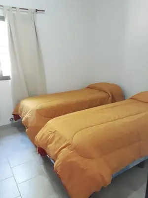 two beds sitting next to each other in a room at Cabañas Corazon de Maria in Merlo
