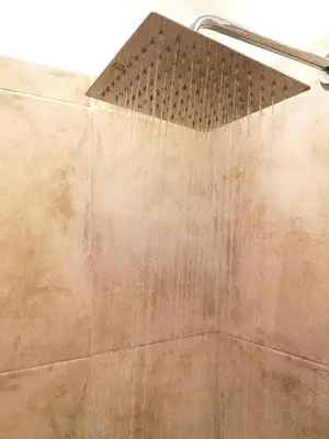 a shower with a shower head in a bathroom at Altos de Chacabuco Planta Baja Apartamento exclusivo premium con cochera gratis in Cordoba