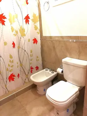 a bathroom with a toilet and a sink at Altos de Chacabuco Planta Baja Apartamento exclusivo premium con cochera gratis in Cordoba
