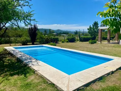 a swimming pool in the yard of a house at Cabañas El Descanso in Potrero de Garay