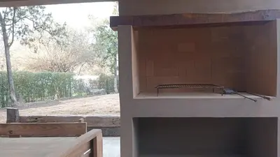a view of a kitchen with a view of a window at Cabañas Kangarú in Santa Rosa de Calamuchita